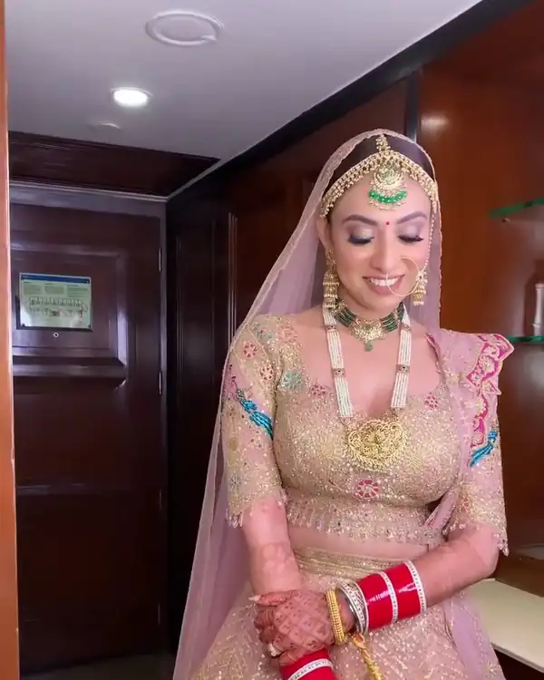Bridal make-up, blush lehenga, ornate hallway